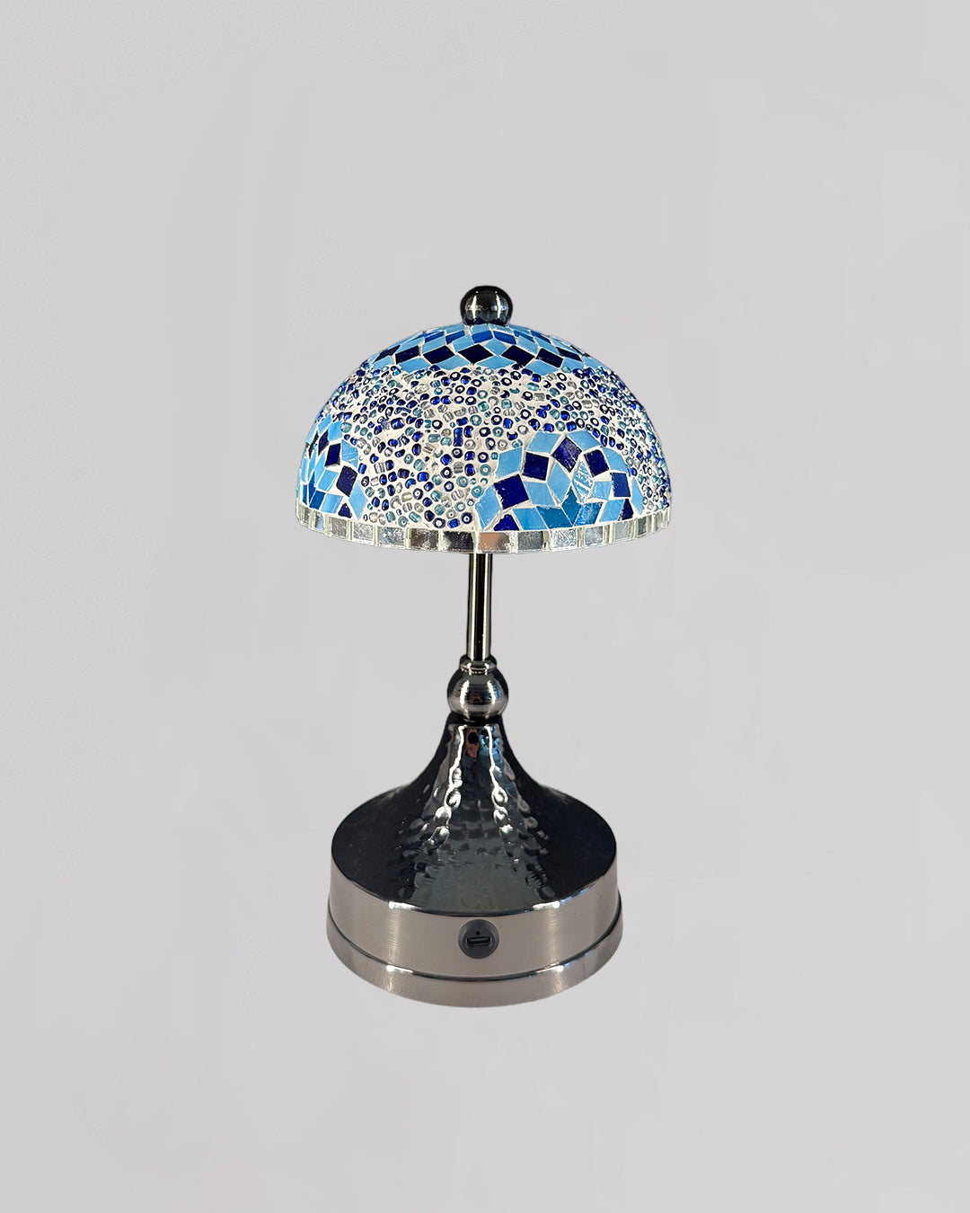 Decorative table lamp with a mosaic blue and silver design on a gray background