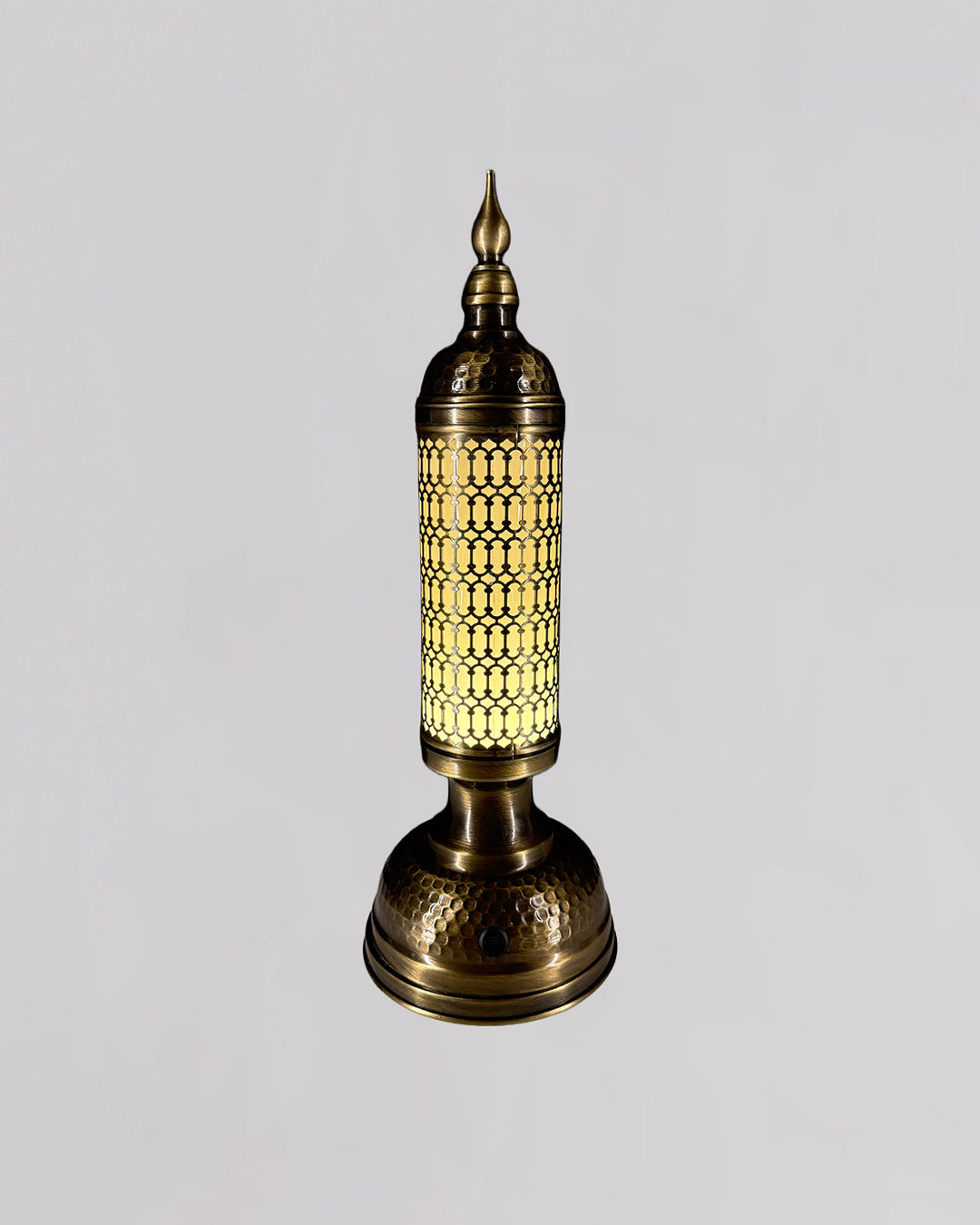 Decorative table lamp with intricate design on a light gray background