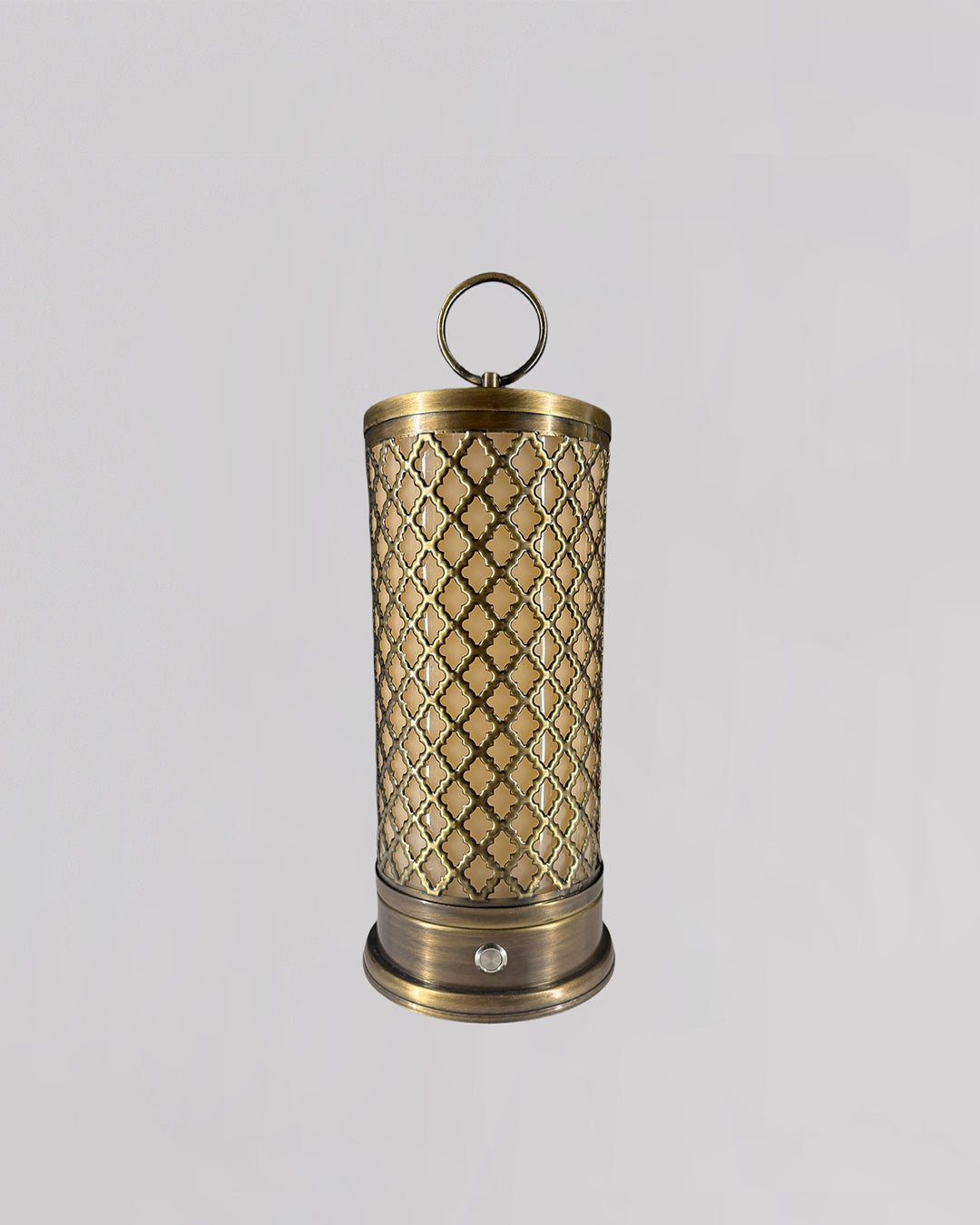 Decorative brass lantern with intricate patterns on a light gray background