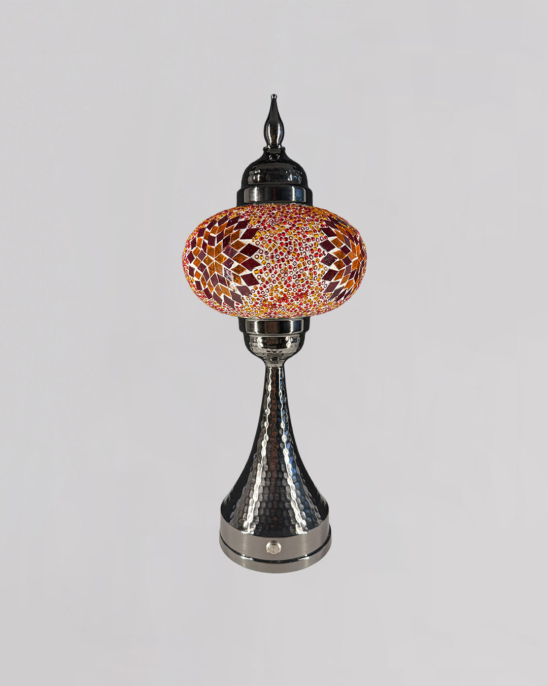 Decorative lamp with mosaic glass shade on a gray background