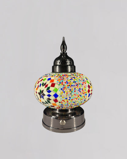 Decorative lamp with colorful mosaic design on a gray background