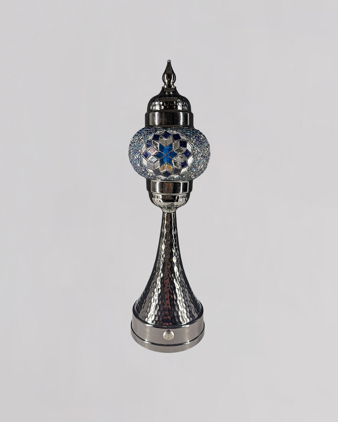 Decorative silver lamp with blue gemstone on a gray background