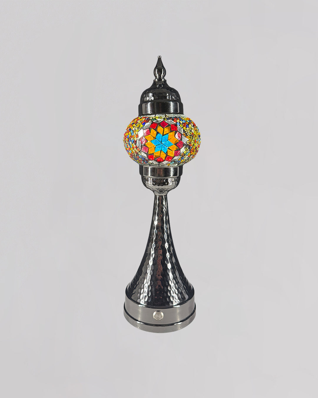 Decorative lamp with colorful mosaic top and metallic base on a gray background