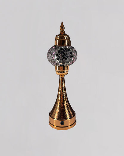 Decorative lamp with gold and crystal design on a light gray background