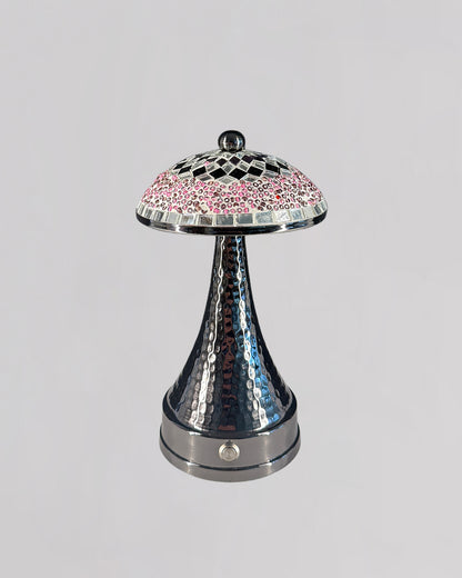 Decorative lamp with a checkered pink and silver shade on a gray background