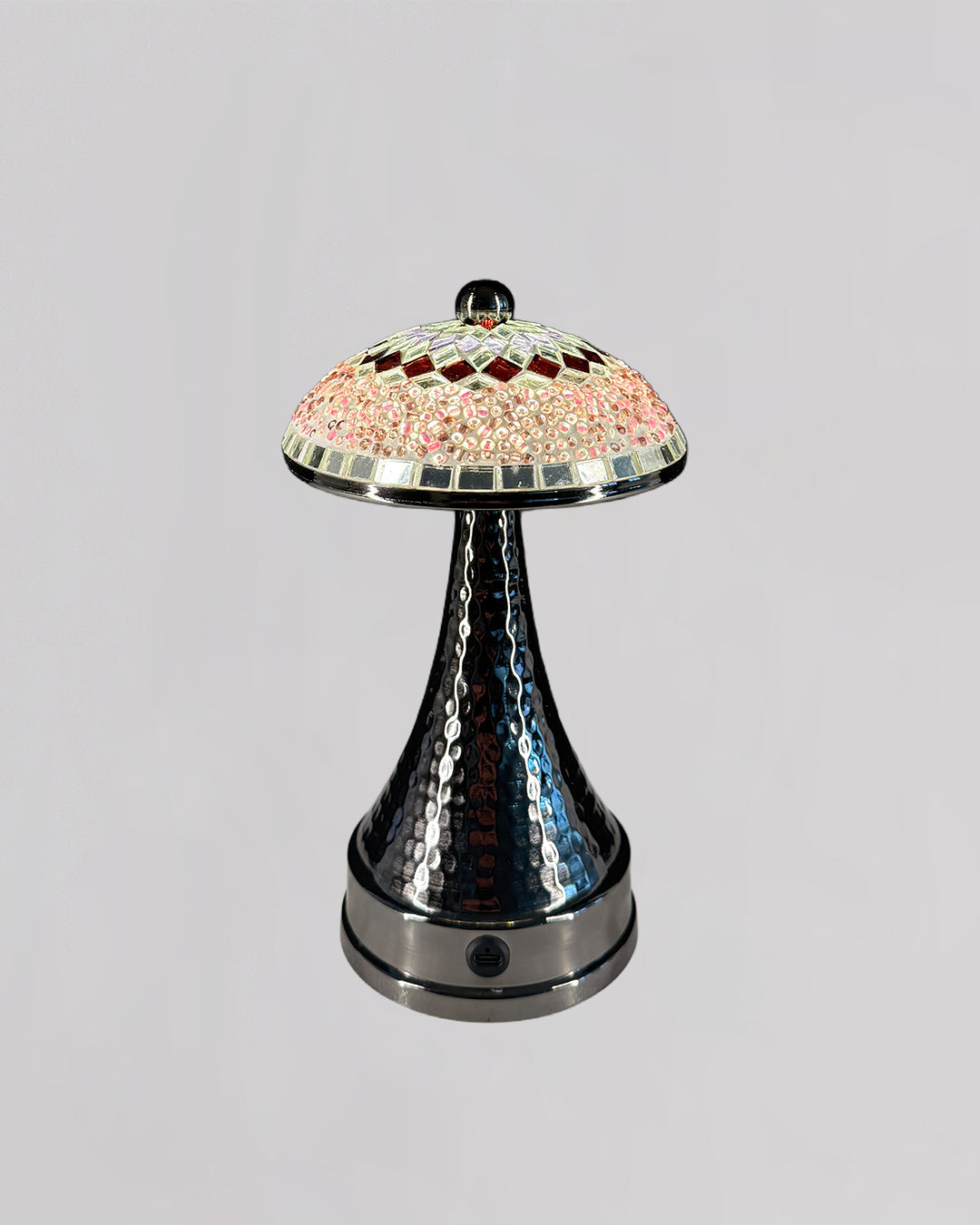 Decorative lamp with a colorful top and metallic base on a gray background