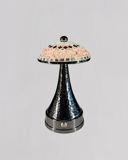 Decorative lamp with a colorful glass shade on a gray background